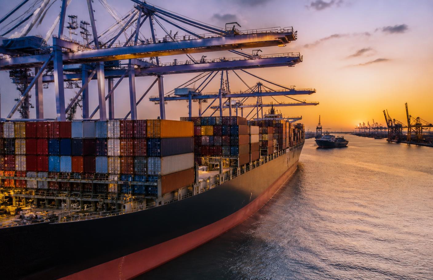 Container port with cargo ship and cranes